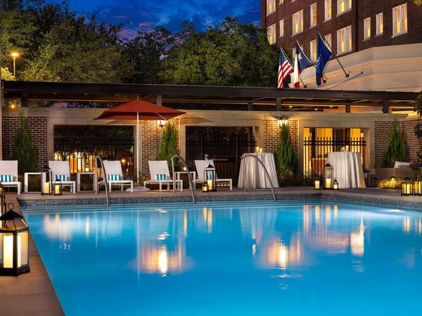 Night view of the swimming pool at Warwick Melrose Dallas