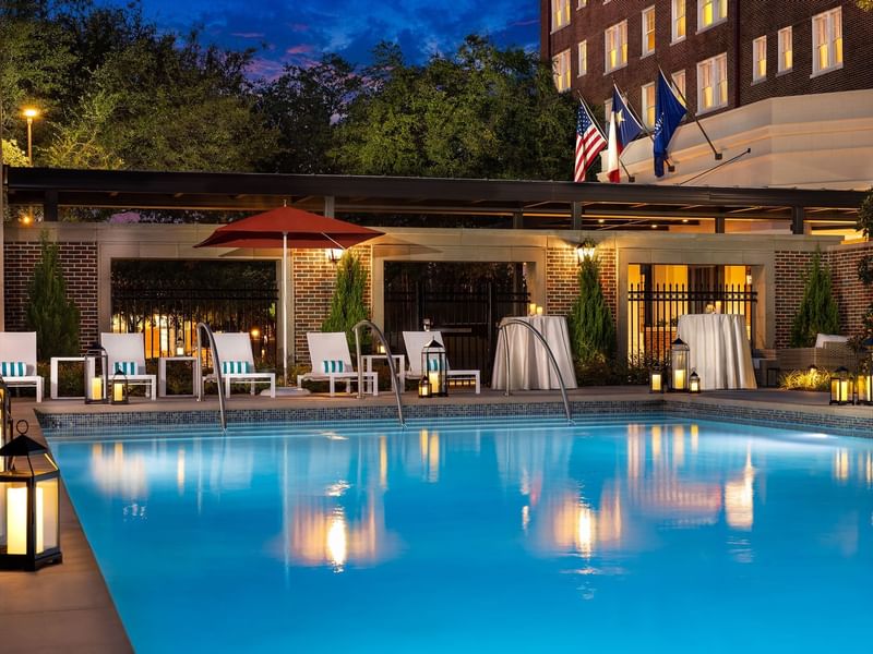 The outdoor pool with lounges at Warwick Melrose Dallas