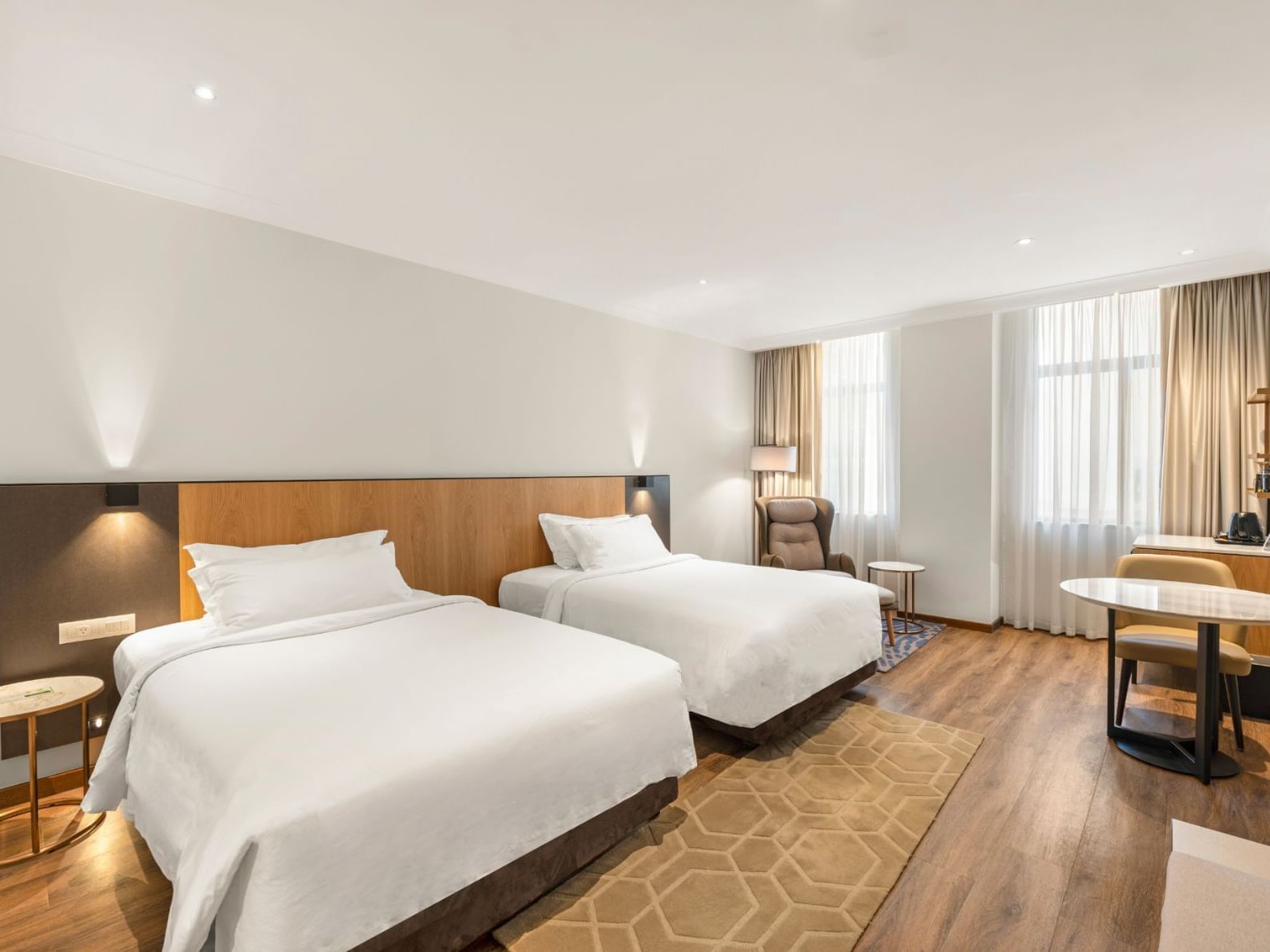 Twin beds, dining table & wooden floors in Signature Deluxe Twin at Grace Hotel Sydney