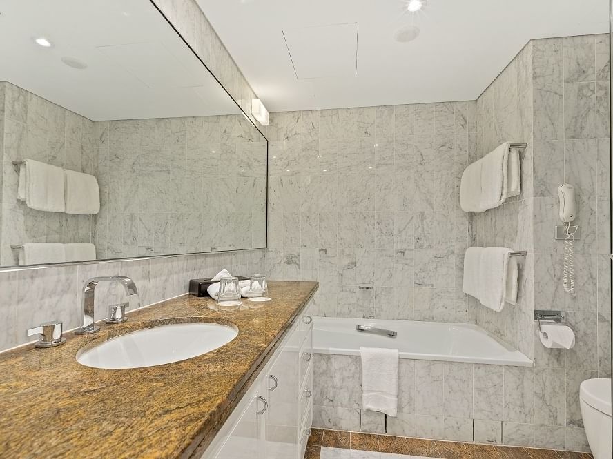 Bathroom with mirror & tub at The Sebel Quay West Suites Sydney