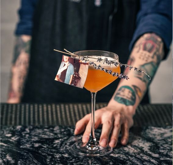 A man holding a glass of wine at ReStays Ottawa