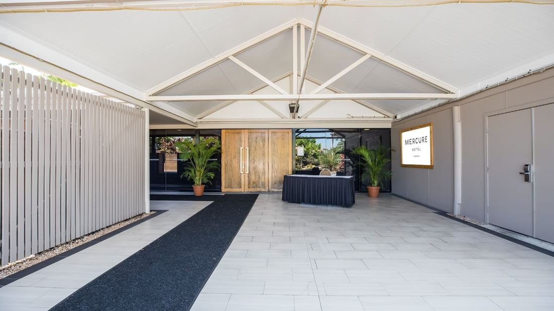 Ballroom entrance featuring wooden doors, table and modern layout at Mercure Hotel Townsville