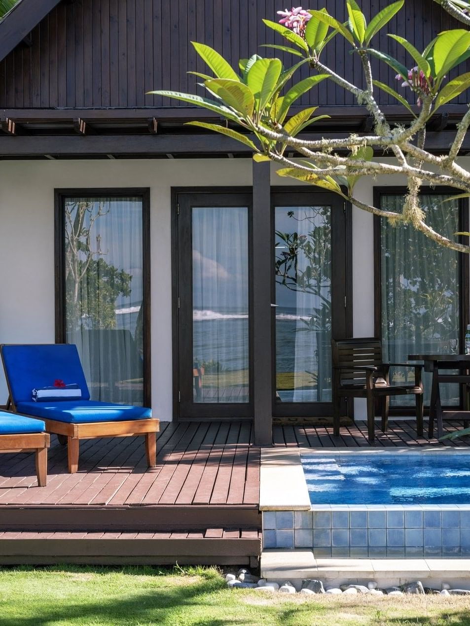 Blue lounge chairs by a private plunge pool in Beach Front Bure with Plunge Pools at Tambua Sands Beach Resort