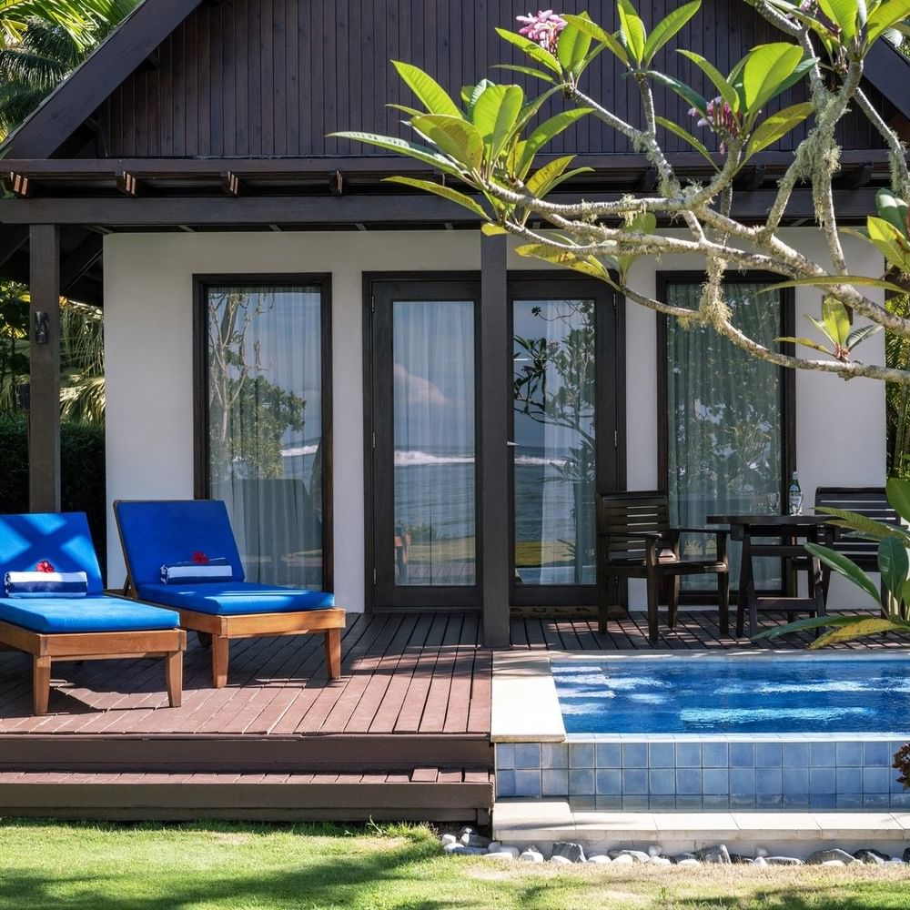 Blue lounge chairs by a private plunge pool in Beach Front Bure with Plunge Pools at Tambua Sands Beach Resort