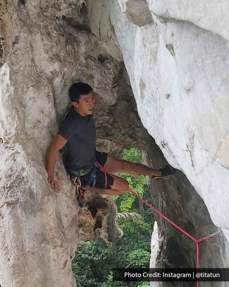 adventurous climber conquering a steep rock formation - Lexis MY
