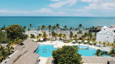 Hotel exterior & saltwater pool at Playa Blanca Beach Resort overlooking the sea