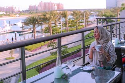 A lady at the Veranda in Bay La Sun Hotel & Marina