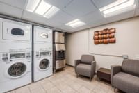 Guest laundry room with ice machine and sitting area