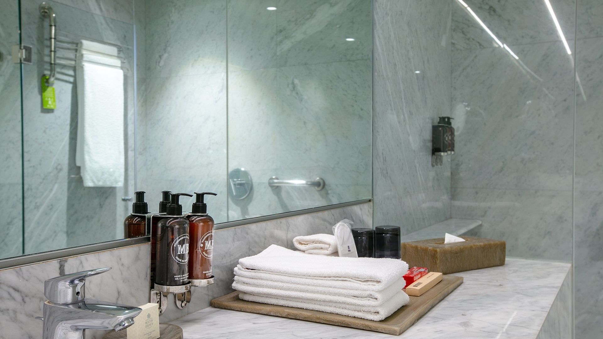 Clean bathroom with towels, toiletries, and marble surfaces at Camino Real Polanco Mexico.