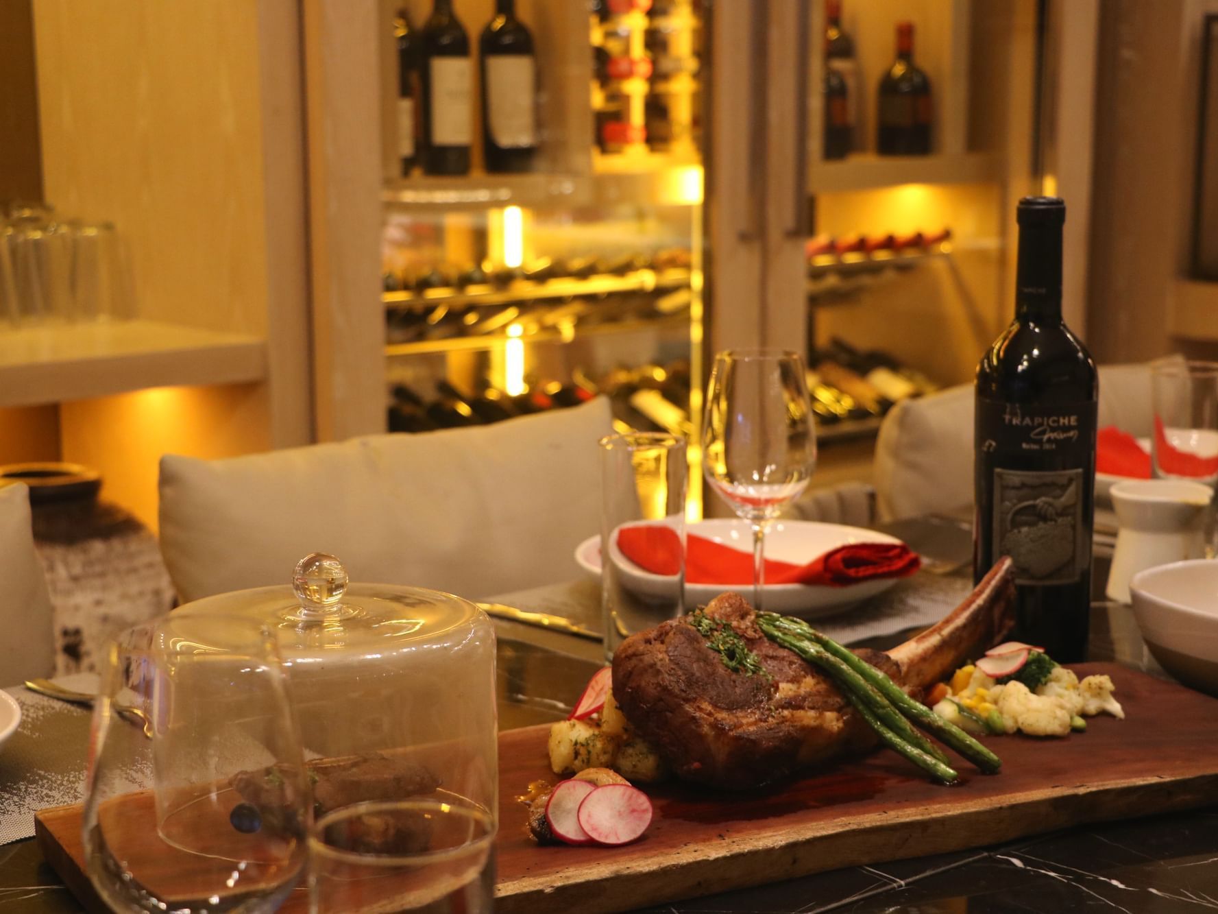 Steak and a glass of wine served on Chef's Table at Alaia Belize Autograph Collection