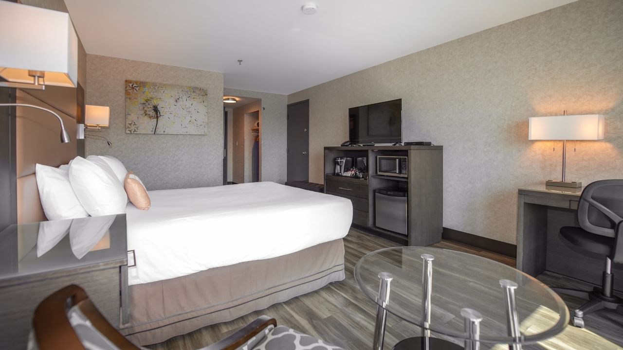 Coast Premium Queen with a queen bed, glass table, and contemporary furnishings at Coast Lonsdale Quay Hotel