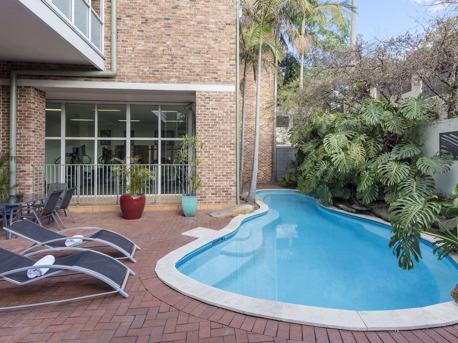 Outdoor mini swimming pool area with pool beds at Nesuto Pennant Hills Apartment Hotel