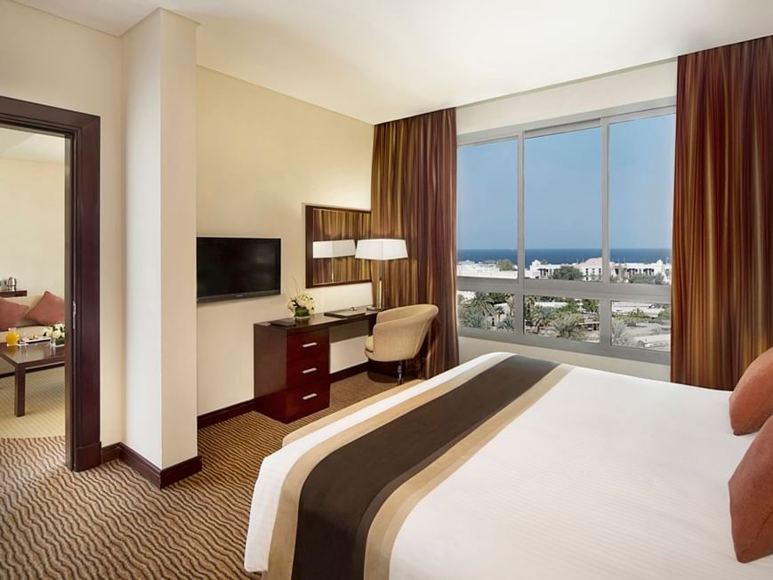 Bedroom & work desk in Seasons Suite at City Seasons Hotels