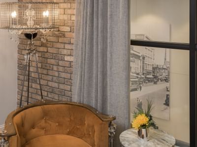 brick wall with yellow sofa chair