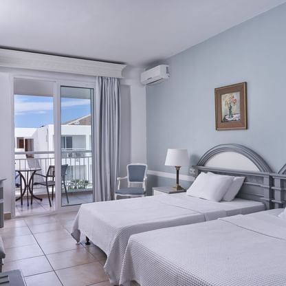 Bedroom & balcony in standard twin room at Sandy Beach Resort