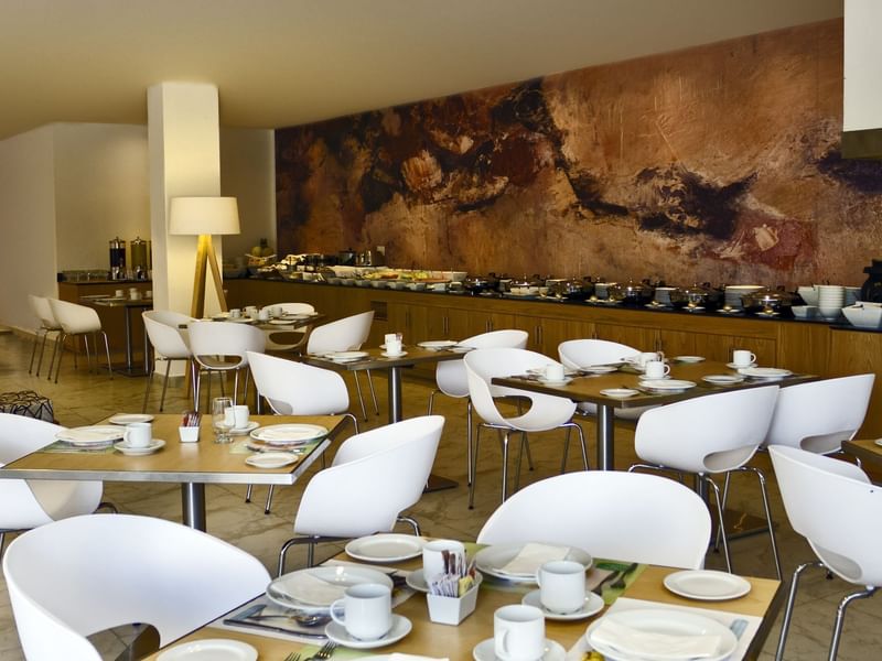 Arranged chairs & tables with teacups at Fiesta Inn Hotels