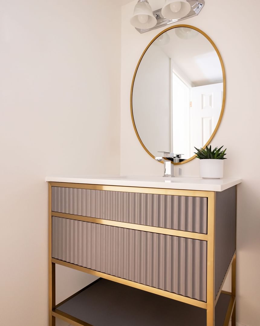 Bathroom with vanity & round mirror in Superior Loft at Retro Suites Hotel