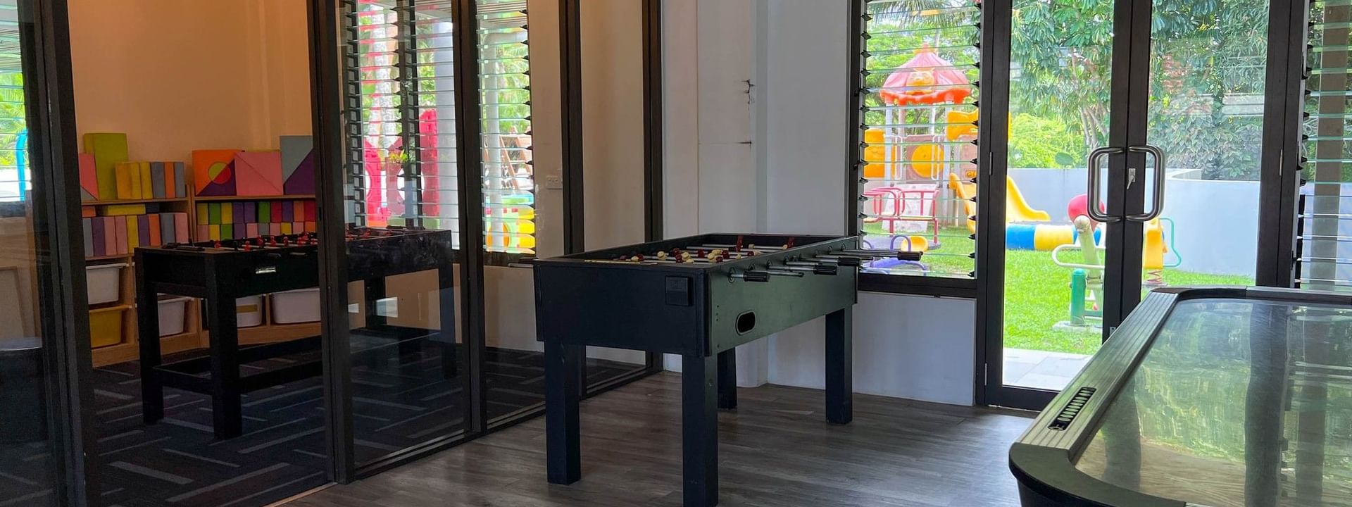 Playroom with table games and outdoor playground view at The Naviti Resort in Korolevu
