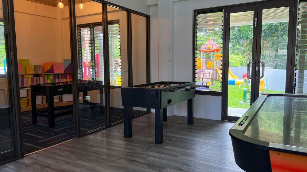 Playroom with table games and outdoor playground view at The Naviti Resort in Korolevu.