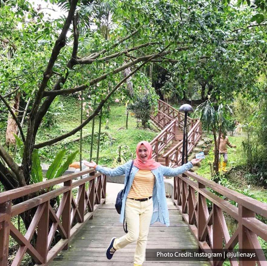 Girl posing on a bridge in KL Bird Park, a famous local attraction near Imperial Lexis Kuala Lumpur