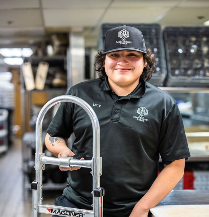 A young man in a black shirt and cap at Stein Eriksen Lodge