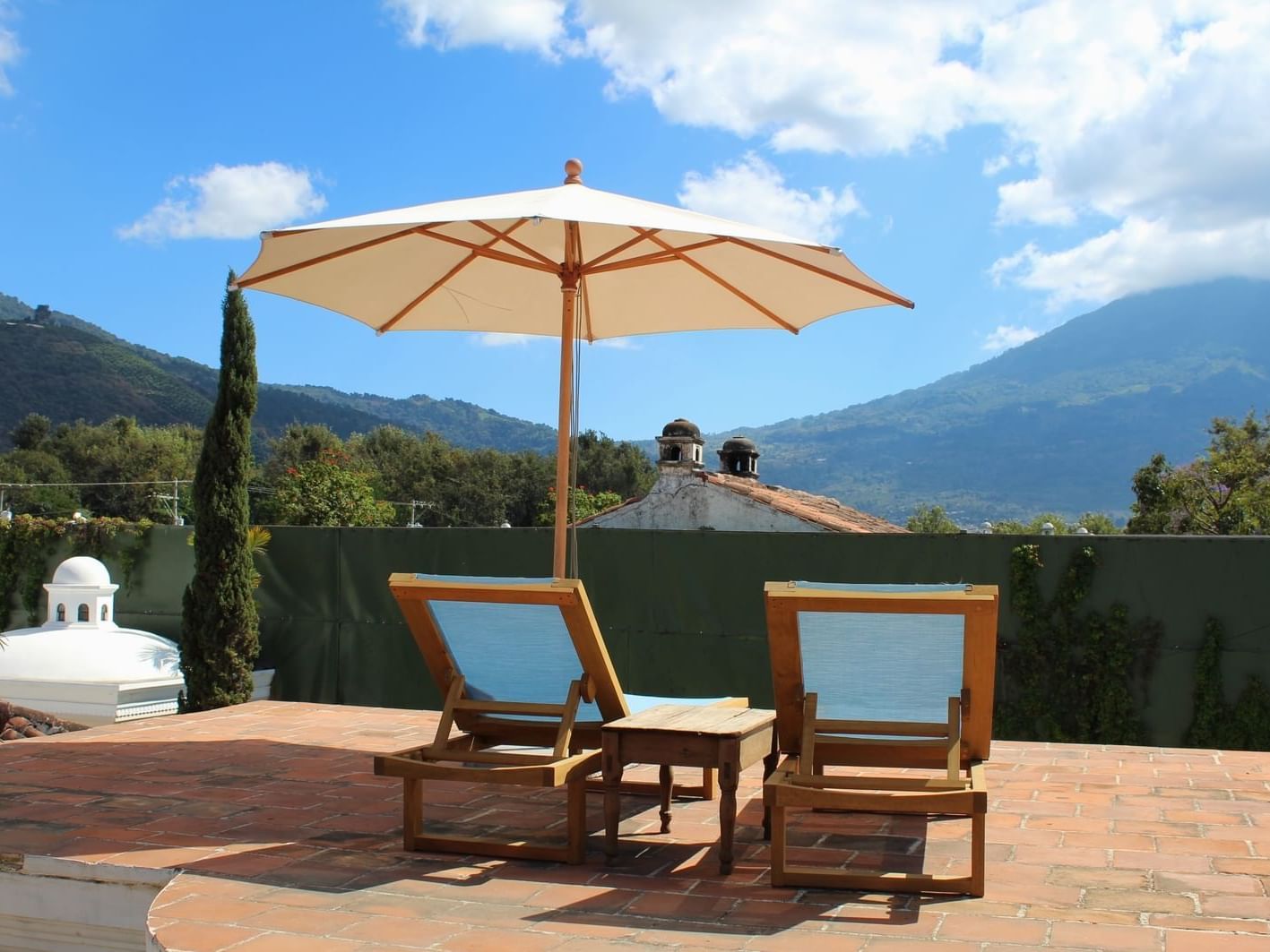 Rooftop lounge area overlooking the mountains & blue sky at Pensativo House Hotel