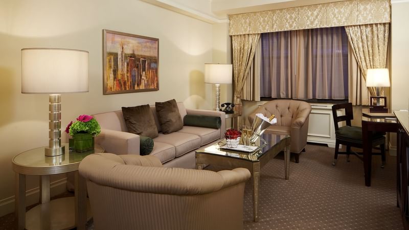 Living area with working table and couch in Premier Suite at Warwick New York