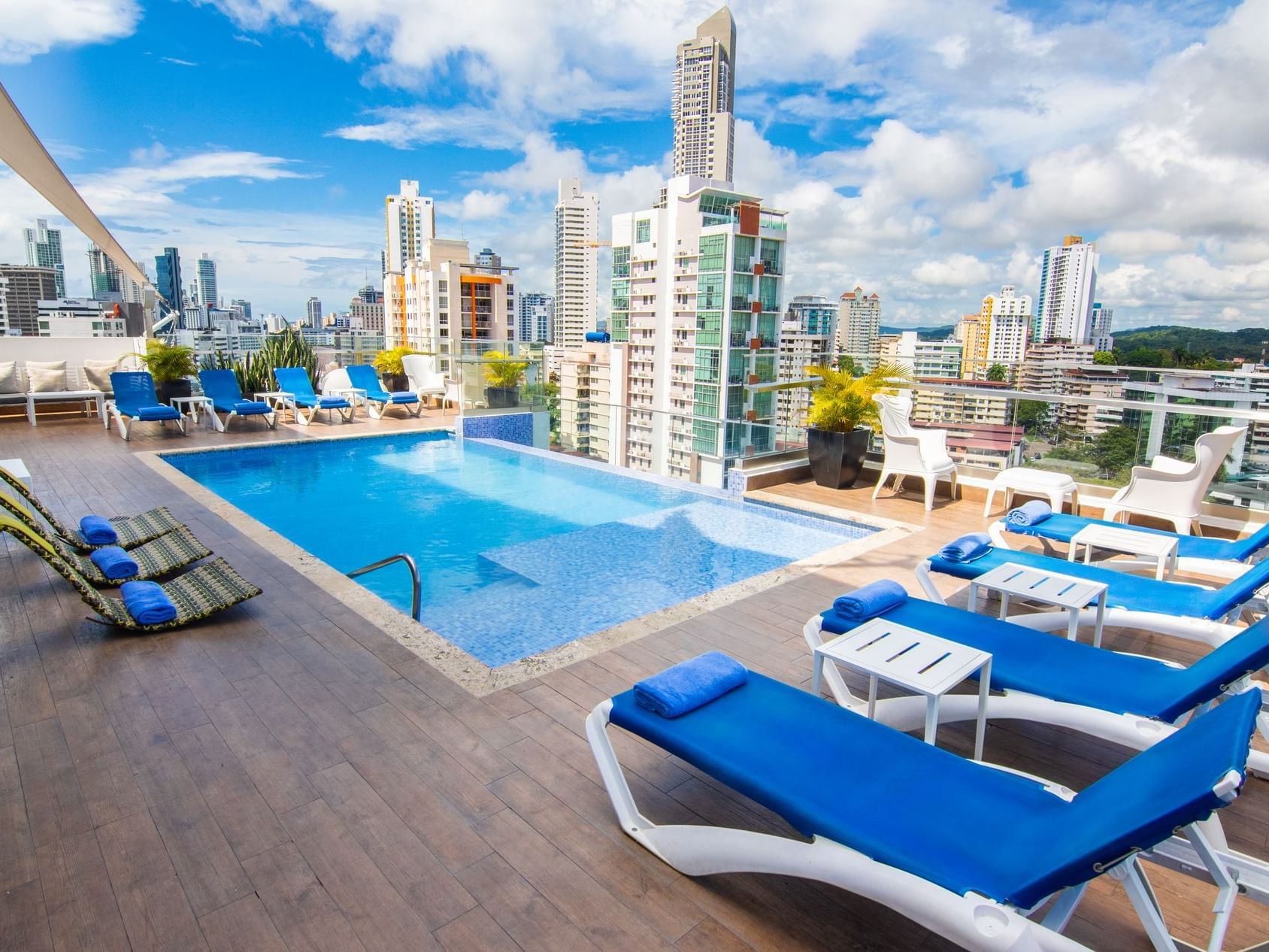 The pool at the rooftop with pool chairs around