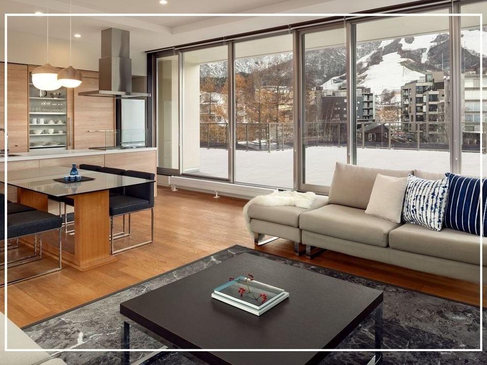 Living area with a city view in a penthouse at Chatrium Niseko