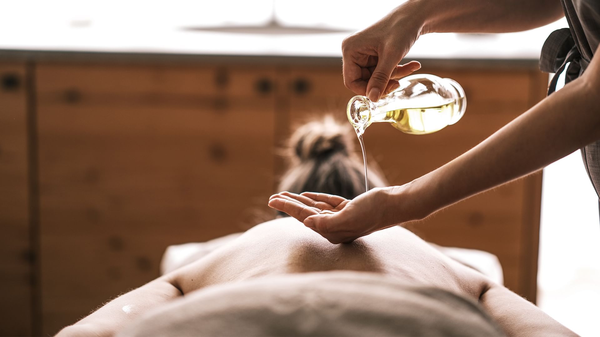 Woman having a oil treatment in the spa at Falkensteiner Hotel Schladming