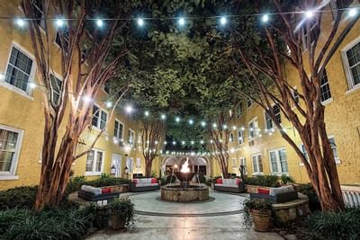 Strings of lights light up a courtyard at Artmore Hotel