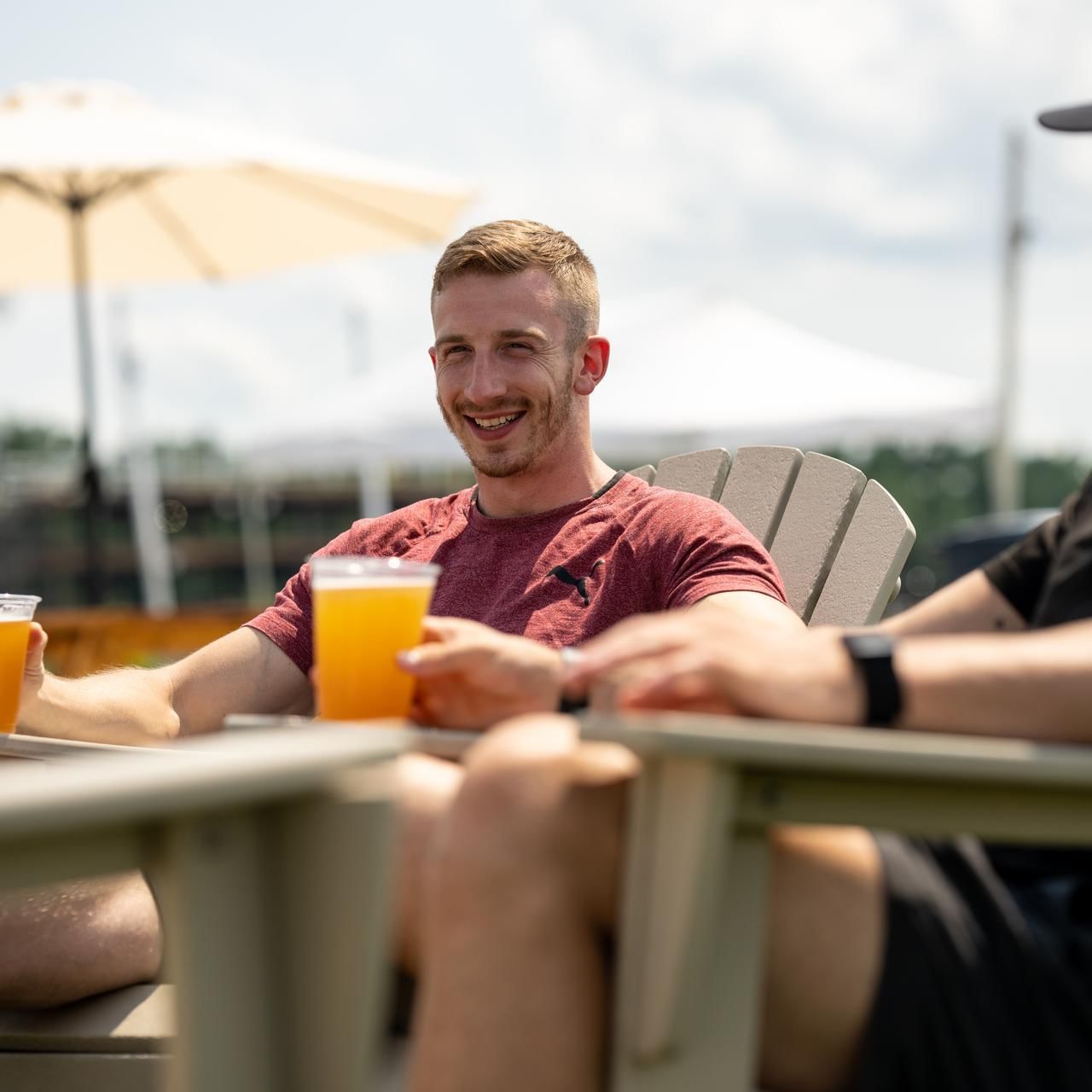 Men hanging out while having beer in Beer Garden at The Artisan Hotel at Tuscan Village