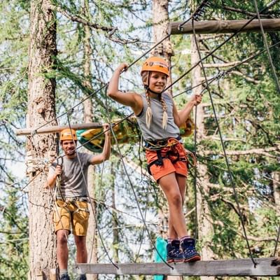 Father & girl engaged in high-wire course, Falkensteiner Hotels