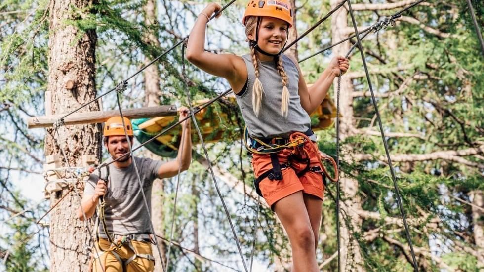 Father & girl engaged in high-wire course, Falkensteiner Hotels