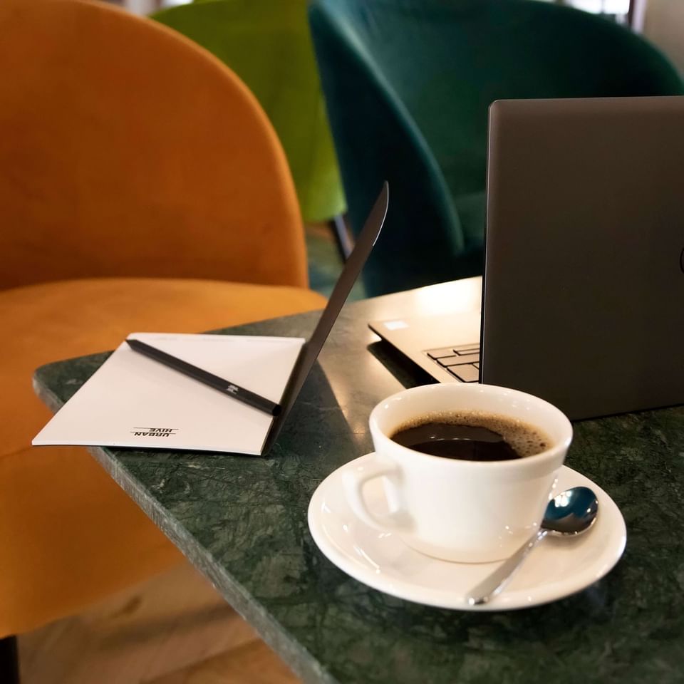 Coffee served beside a laptop & a hotel card, Urban Hive Milano