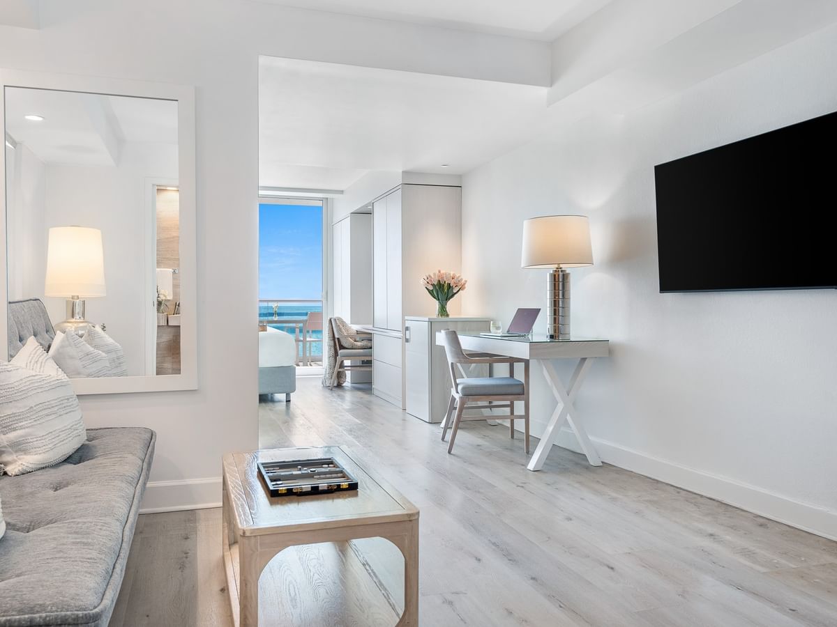Living area with a plush sofa and next to a work desk in King Ocean View Suites at Grand Beach Hotel Surfside