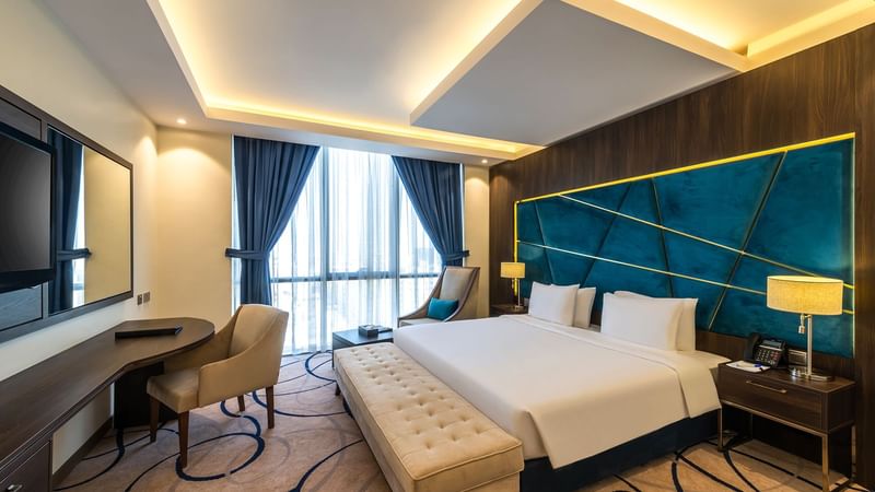 Comfy bed, working table and sitting area in Standard Room at Warwick Riyadh