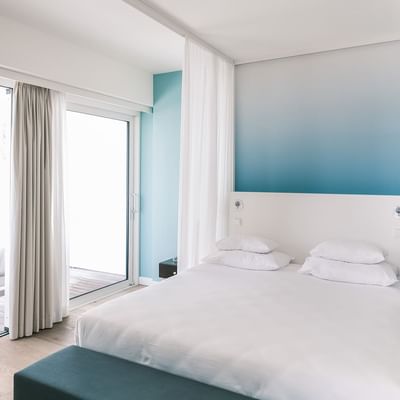 Large bed in Burano Suite sea view at Falkensteiner Hotels