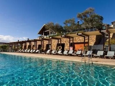 View of the lounges by the pool at Pullman Bunker Bay Resort