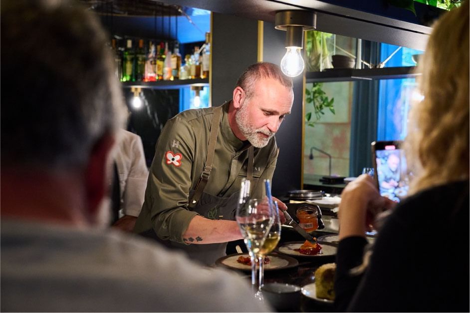 Chef setting the dishes on a table in a Restaurant at Almanac Barcelona