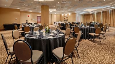 Tables and chairs in large ballroom