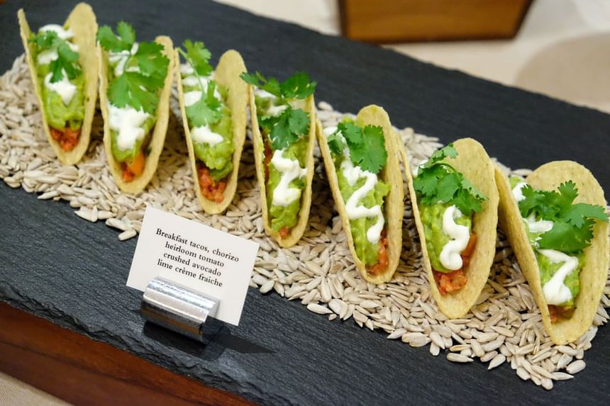 Breakfast tacos filled with chorizo, guacamole, heirloom tomato, and topped with cilantro at Park Hyatt Saigon