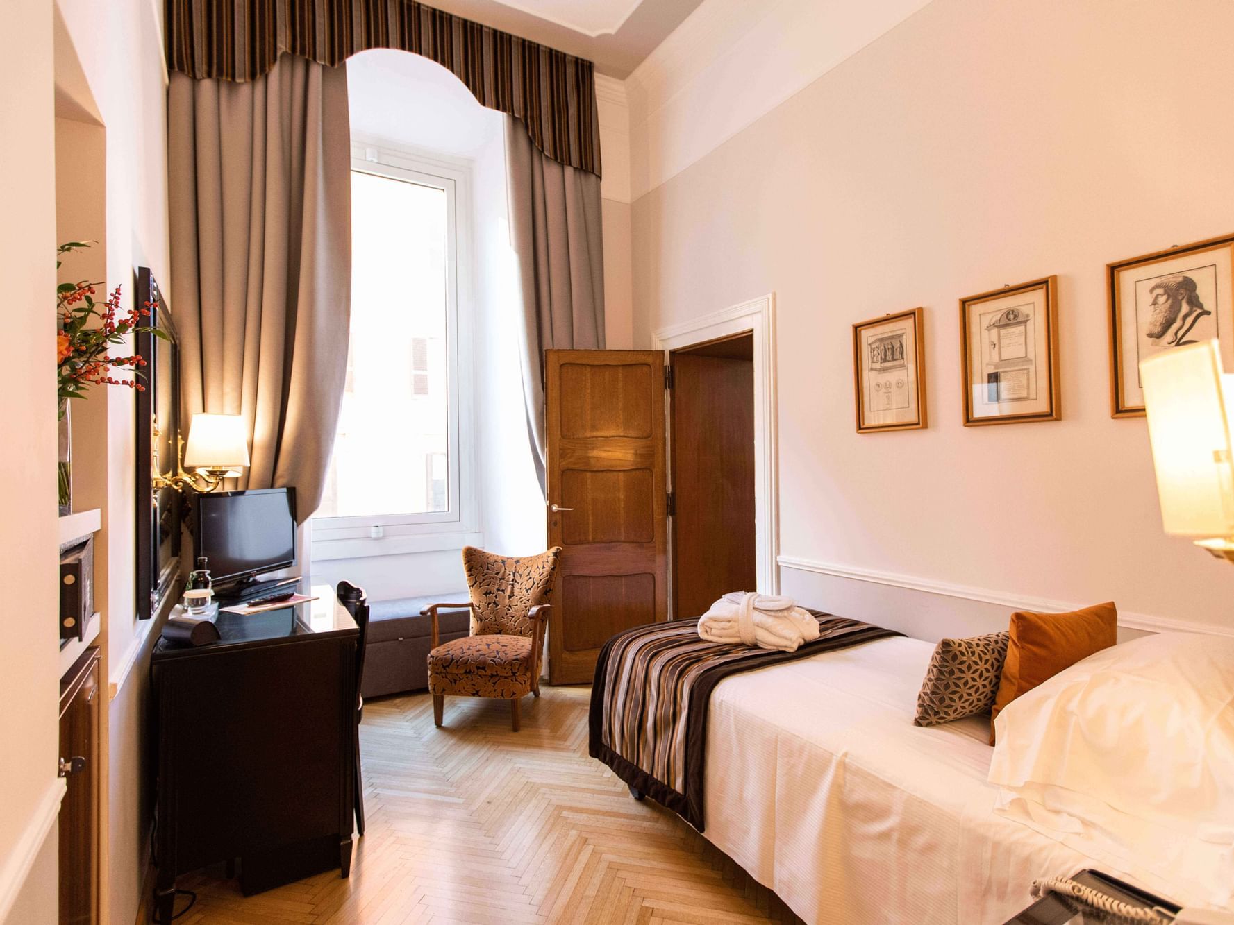 King bed, lounge & work desk in Single Room at Bettoja Hotel Massimo D'Azeglio