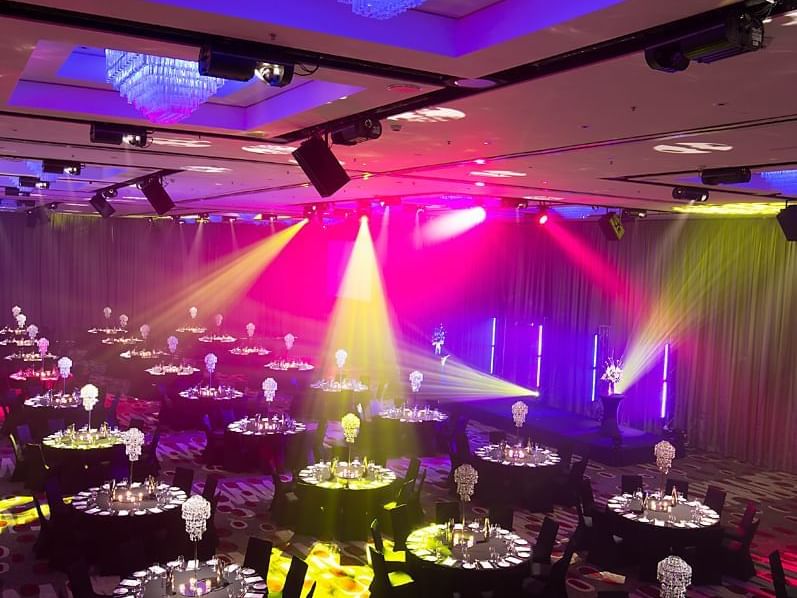 Ballroom arranged with colorful lights and dining at Pullman Albert Park