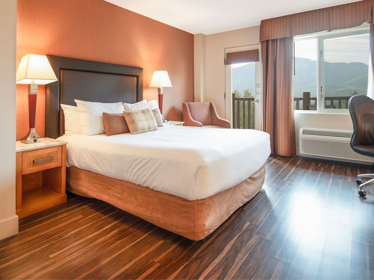 Hotel guest room with king bed and a balcony