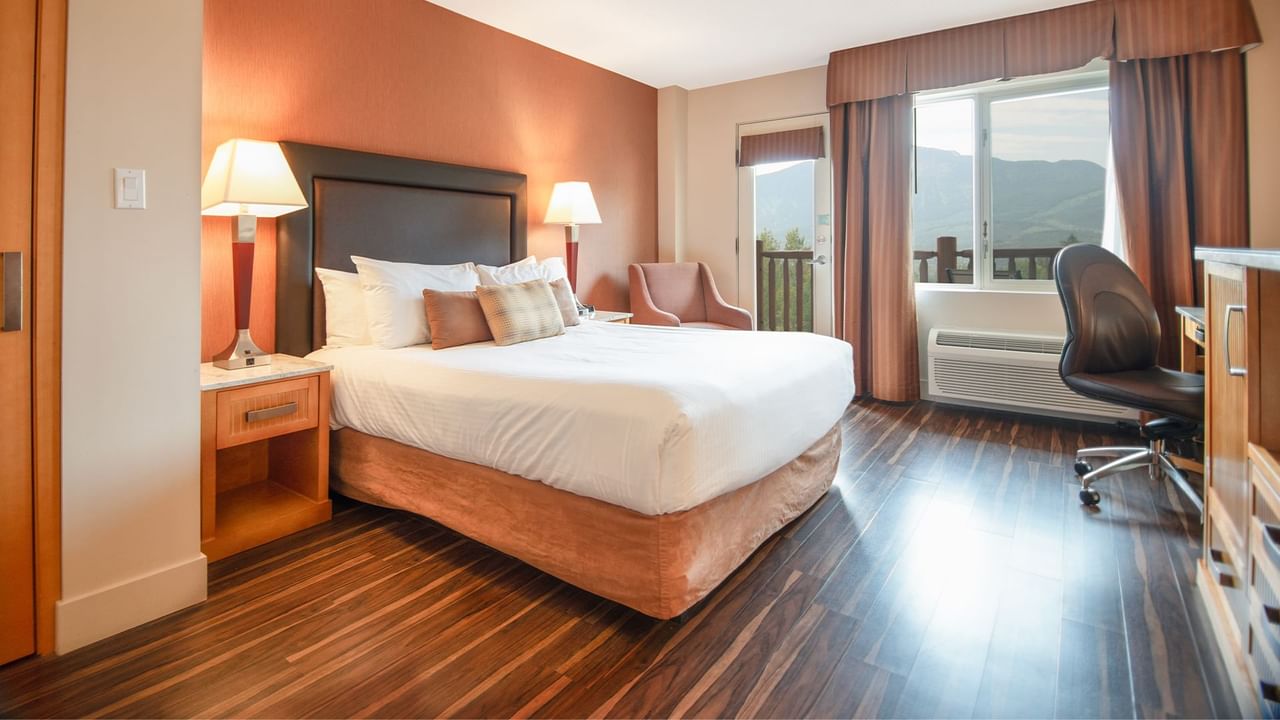 Hotel guest room with king bed and a balcony
