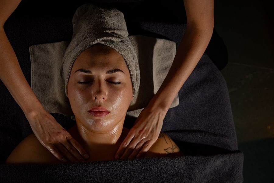 A woman having a body massage in May Fair Spa at The May Fair Hotel