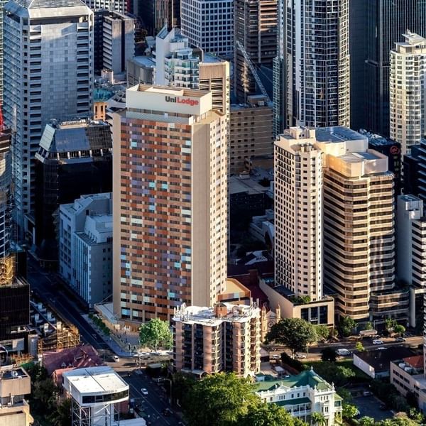 Tall buildings in a city with UniLodge Brisbane City visible among them.