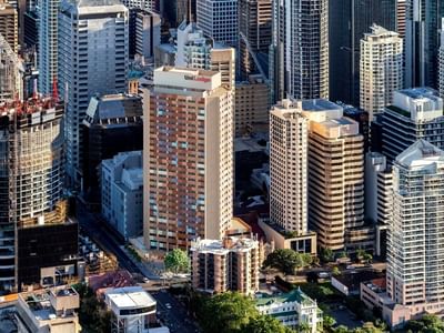 Tall buildings in a city with UniLodge Brisbane City visible among them.