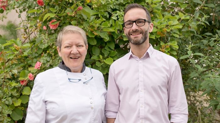 Two workers smiling to the camera at Hotel du Pont Roupt